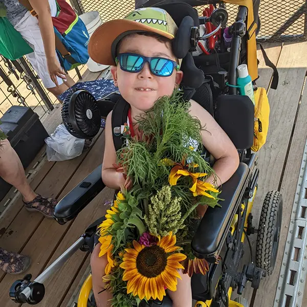 Gabriel holding sunflowers